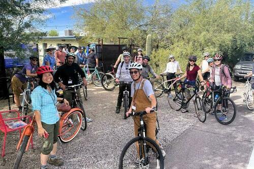 Half a dozen people with bicycles