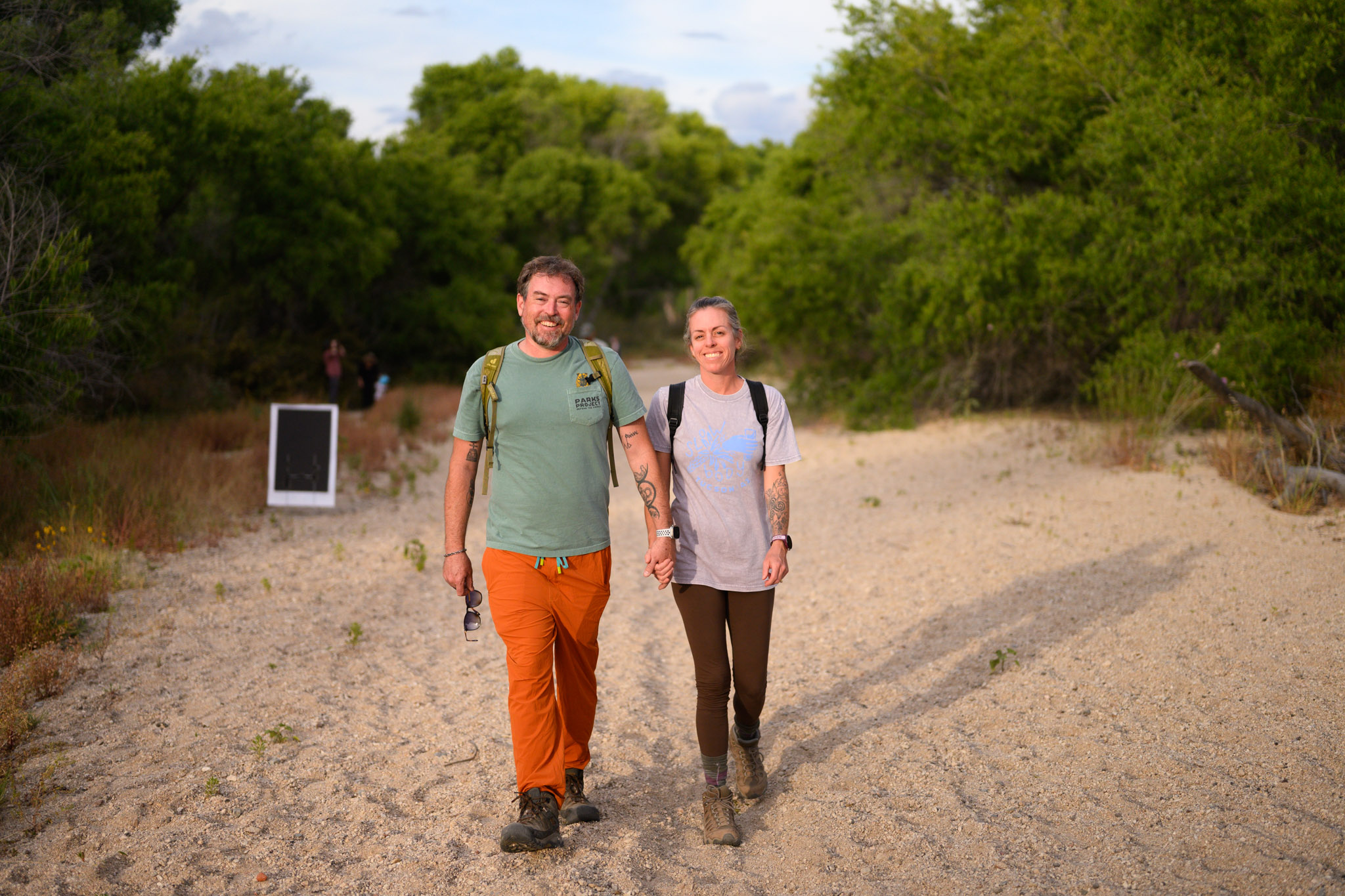 couple walking through creek bed