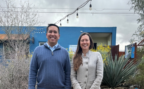 Co-Executive Directors Oscar Lai and Lisa Shipek standing in front of the Living Lab's Welcome Center on a cloudy day