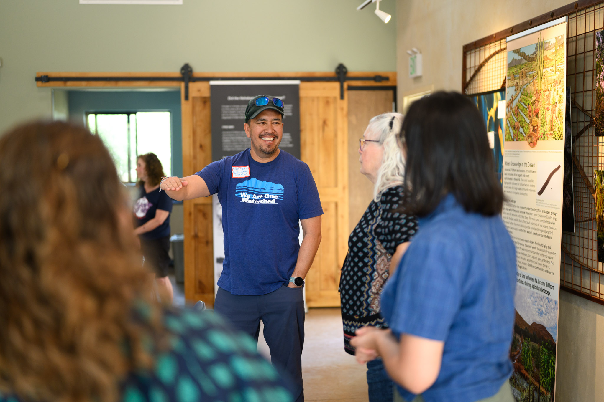 Group of people in the Learning Center looking at an Arizona Water for All exhibit