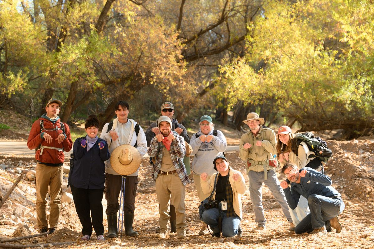 a group of volunteers and staff adopt a beaver pose while surveying for beaver sign on the San Pedro