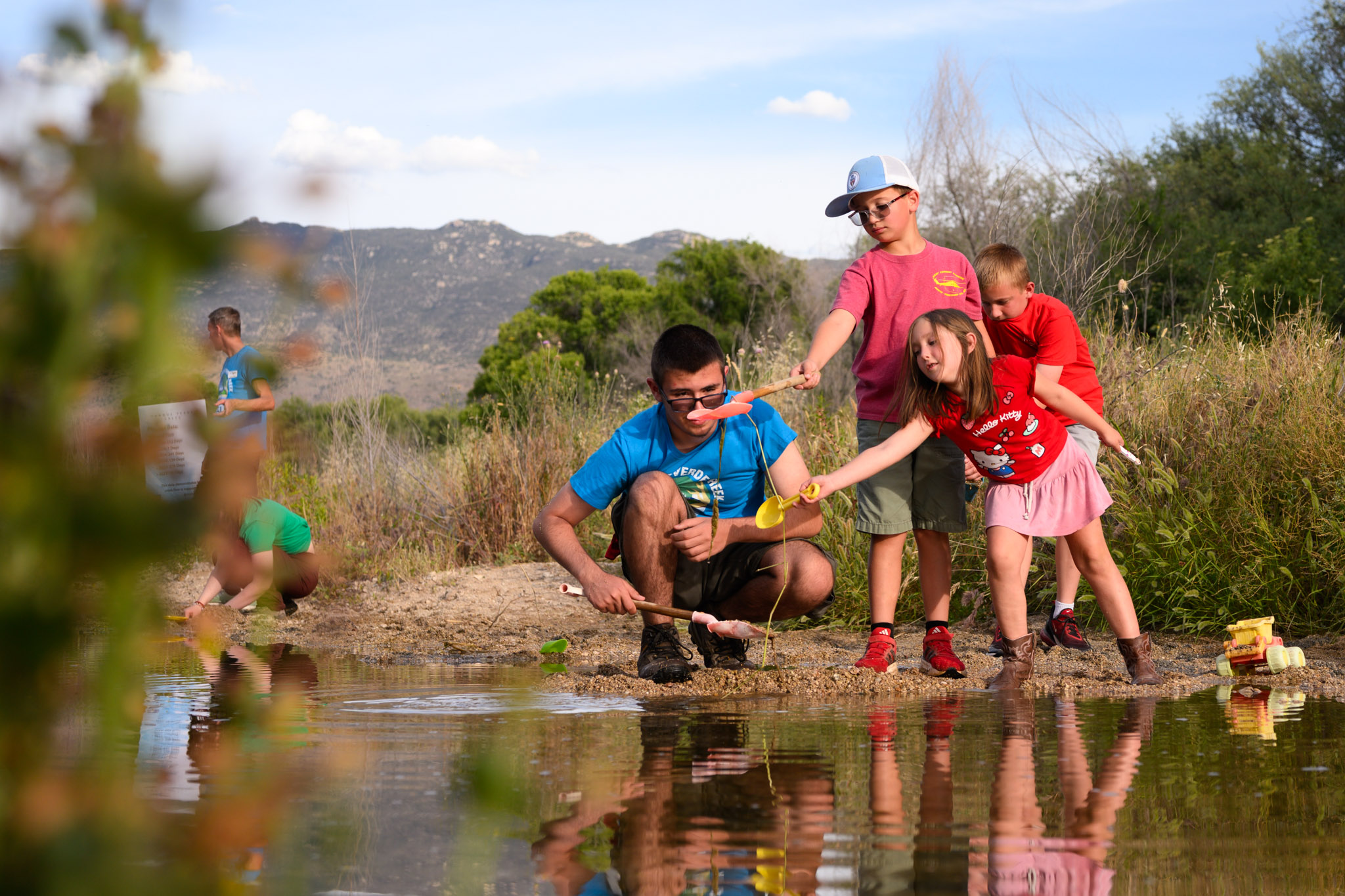 Children playing in flowing water in Tanque Verde Creek