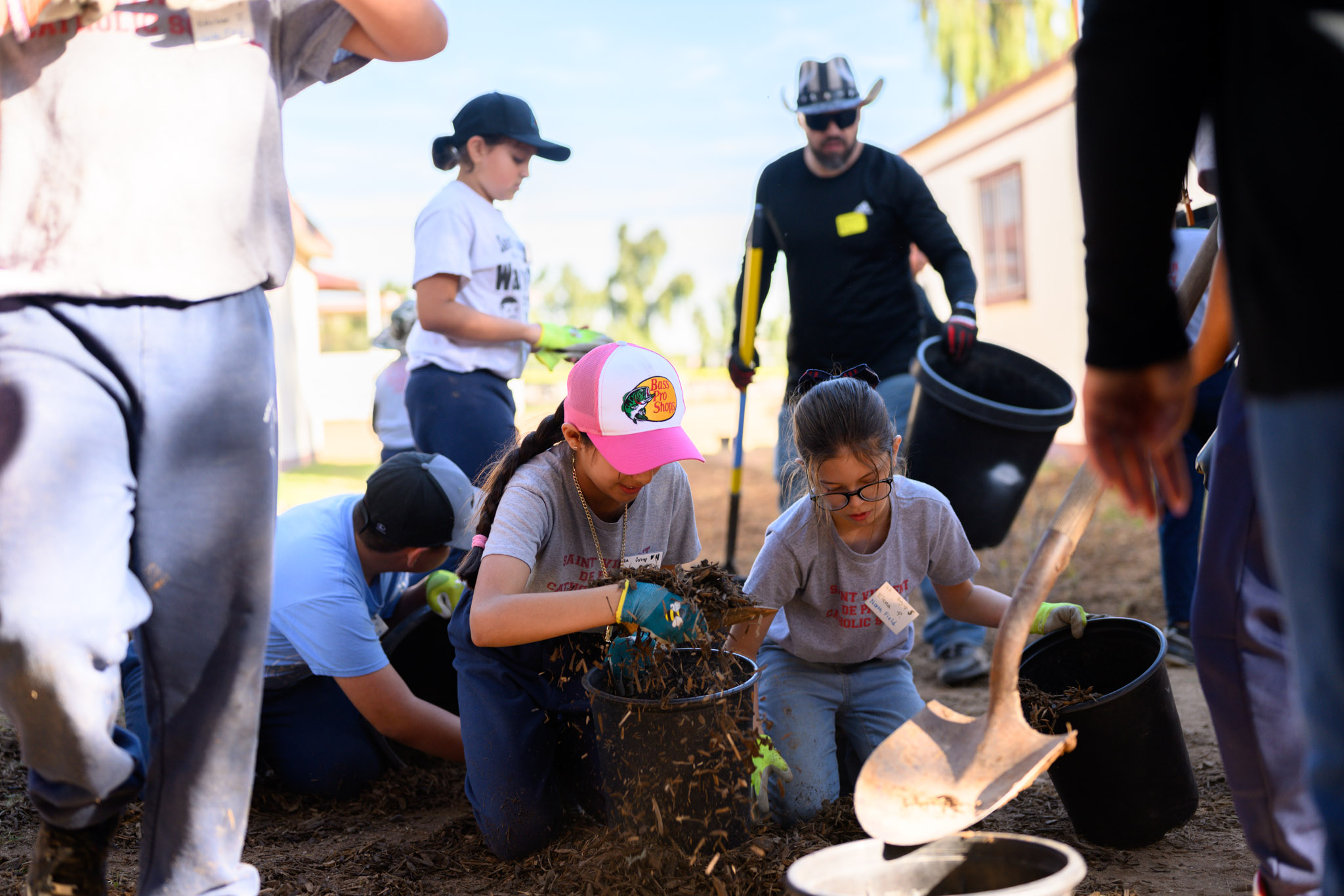 school aged kids planting trees