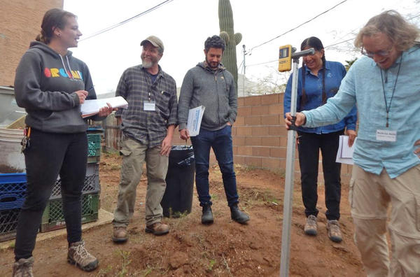 Course participants check elevations as they plan and design water harvesting earthworks