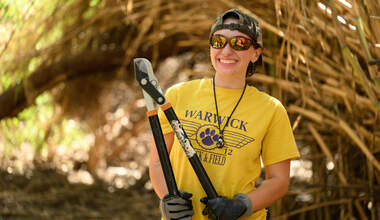 arundo person holding lopper