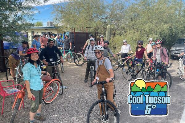 a group of bicyclists smiling at the camera