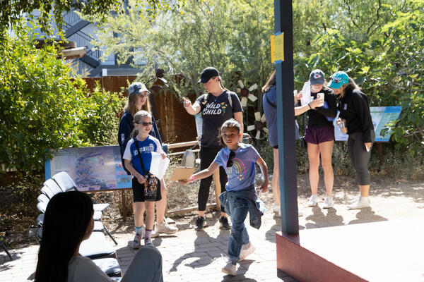 children and adults outside at the Food Forest, WMG's Living Lab