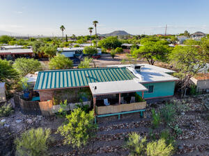 View of outdoor shower and armored wall along the arroyo. 