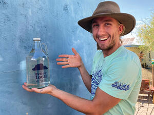 Jonah with a Hydrate Local growler at the Living Lab. 
