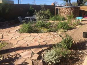 One of two water-harvesting storage tanks at Kay Baumann’s home. It matches the flagstones, rock planters.