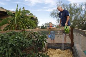 Mencke, with his 3-year-old son, Reef, defrayed the cost of his collection system with a $2,000 rebate from Tucson Water.