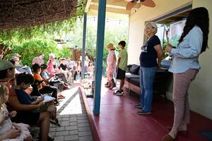 adults and children on back porch of Living Lab adobe