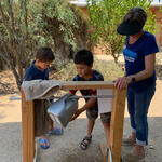 Kids use a tippy tap at the Living Lab.