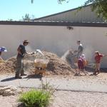 Hermosa Montessori School water harvesting project - volunteers shoveling mulch into wheelbarrows
