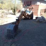 Valencia Middle School water harvesting earthworks - large machine excavating basin