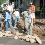 Workshop volunteers dig out basins.