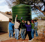 Co-op group moving a cistern.